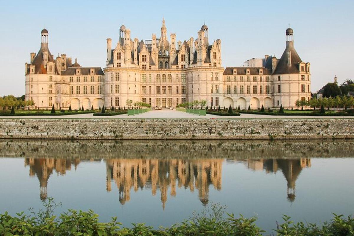 a large castle with its reflection in the water
