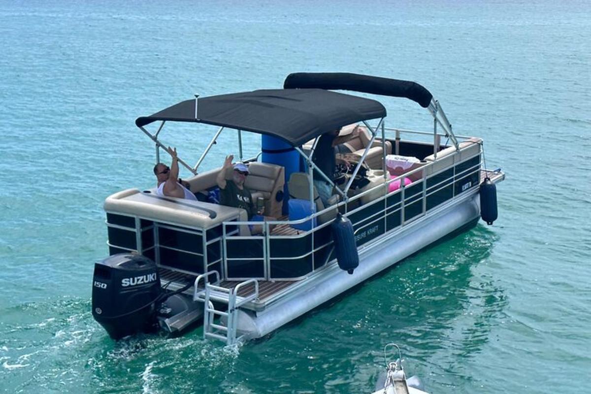a group of people on a pontoon boat in the water