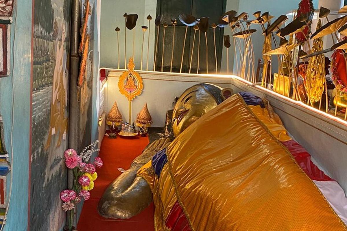 a statue of a person laying on a couch in a room