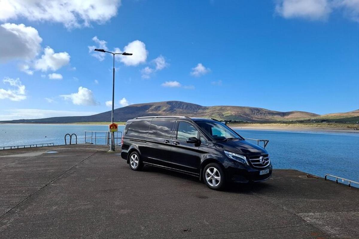 a black van parked next to a body of water