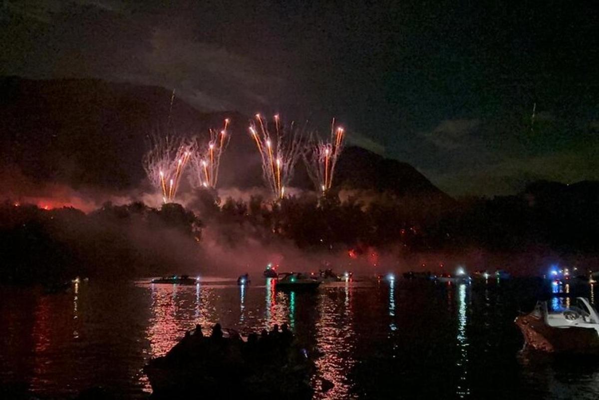 a fireworks display on the water at night