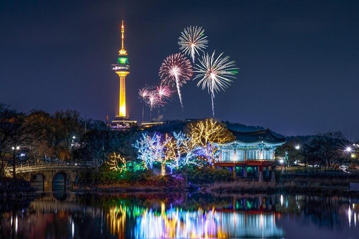 a fireworks display with the osaka tower in the background