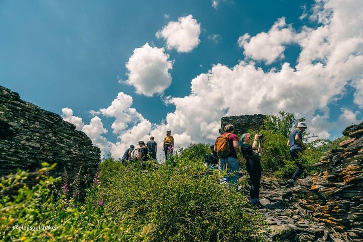 a group of people walking on a mountain