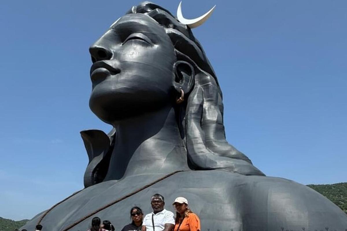 a group of people standing in front of a statue