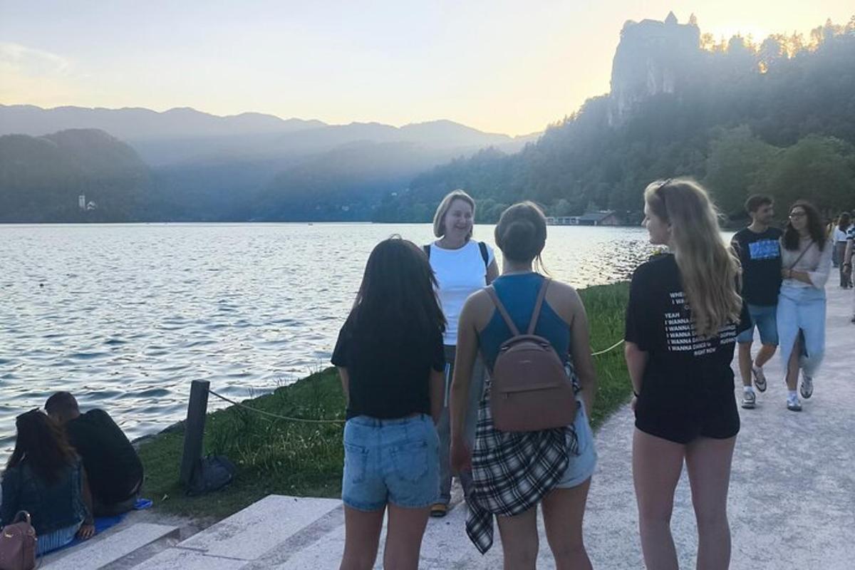 a group of people standing next to a body of water