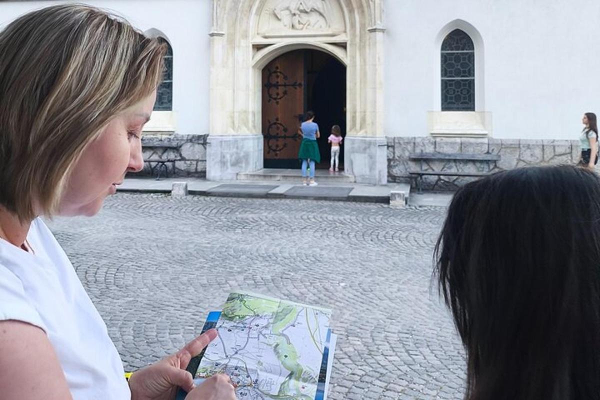 two women looking at a map in front of a building