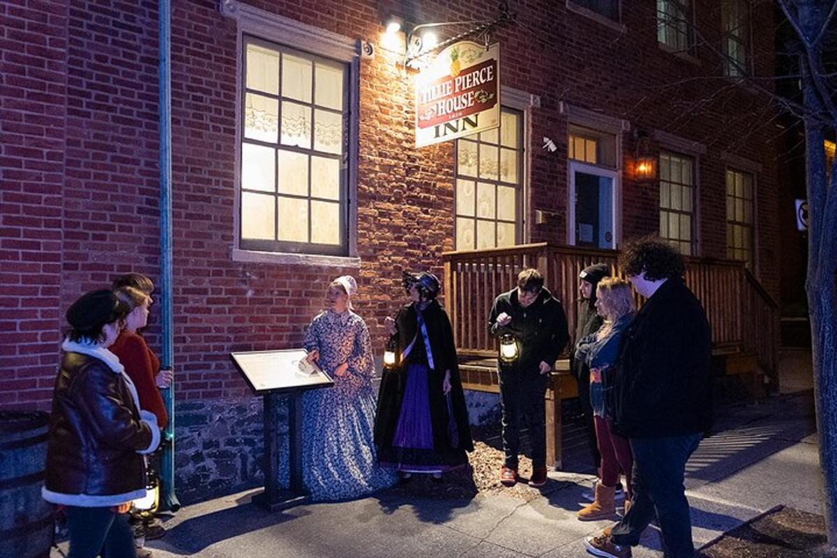 a group of people standing outside of a brick building