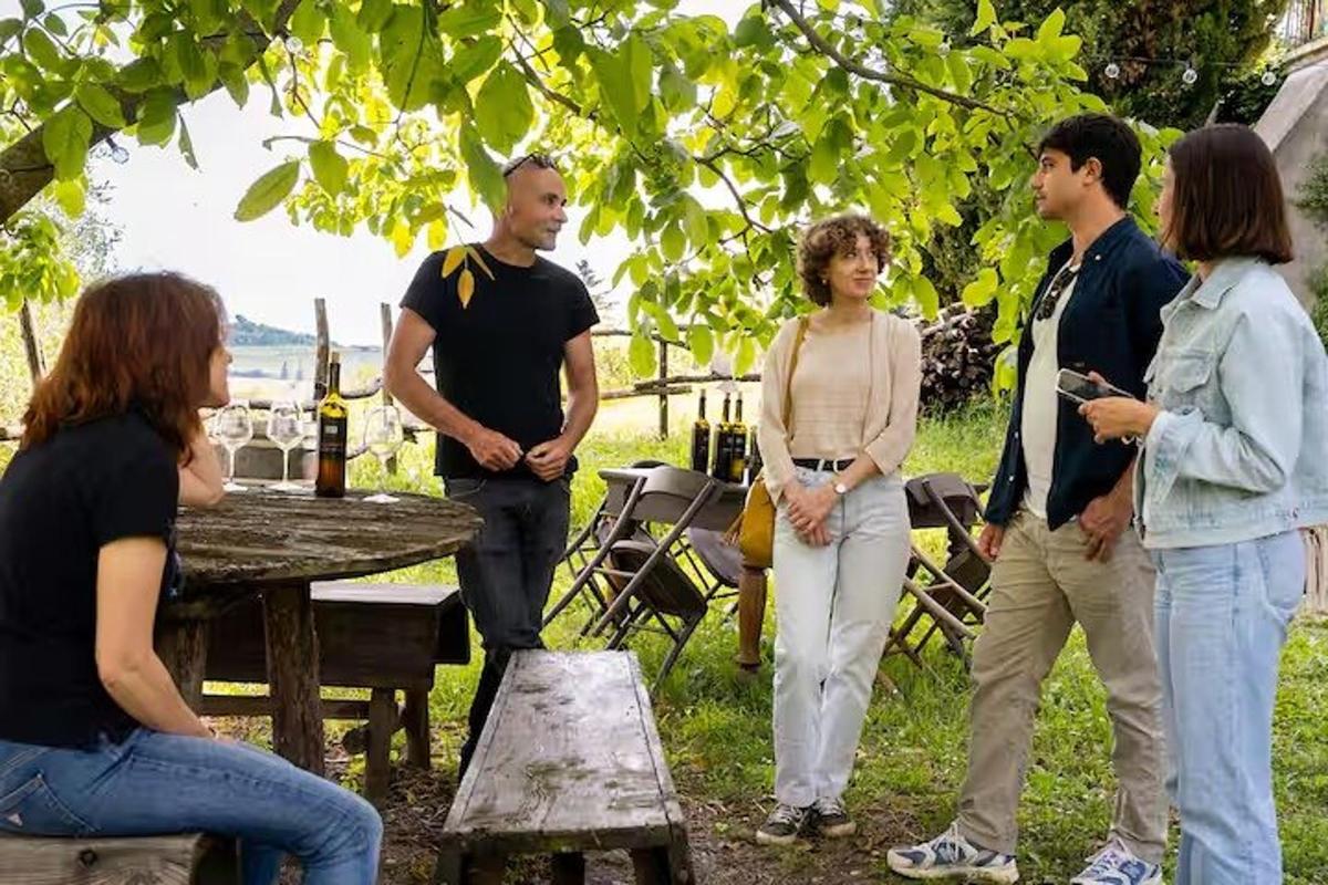 a group of people standing around a picnic table