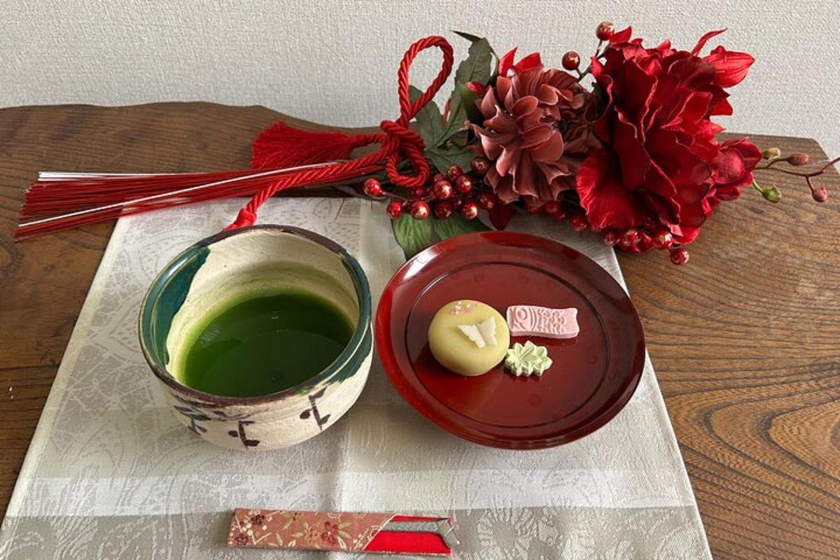 a table with a cup of coffee and a vase of flowers