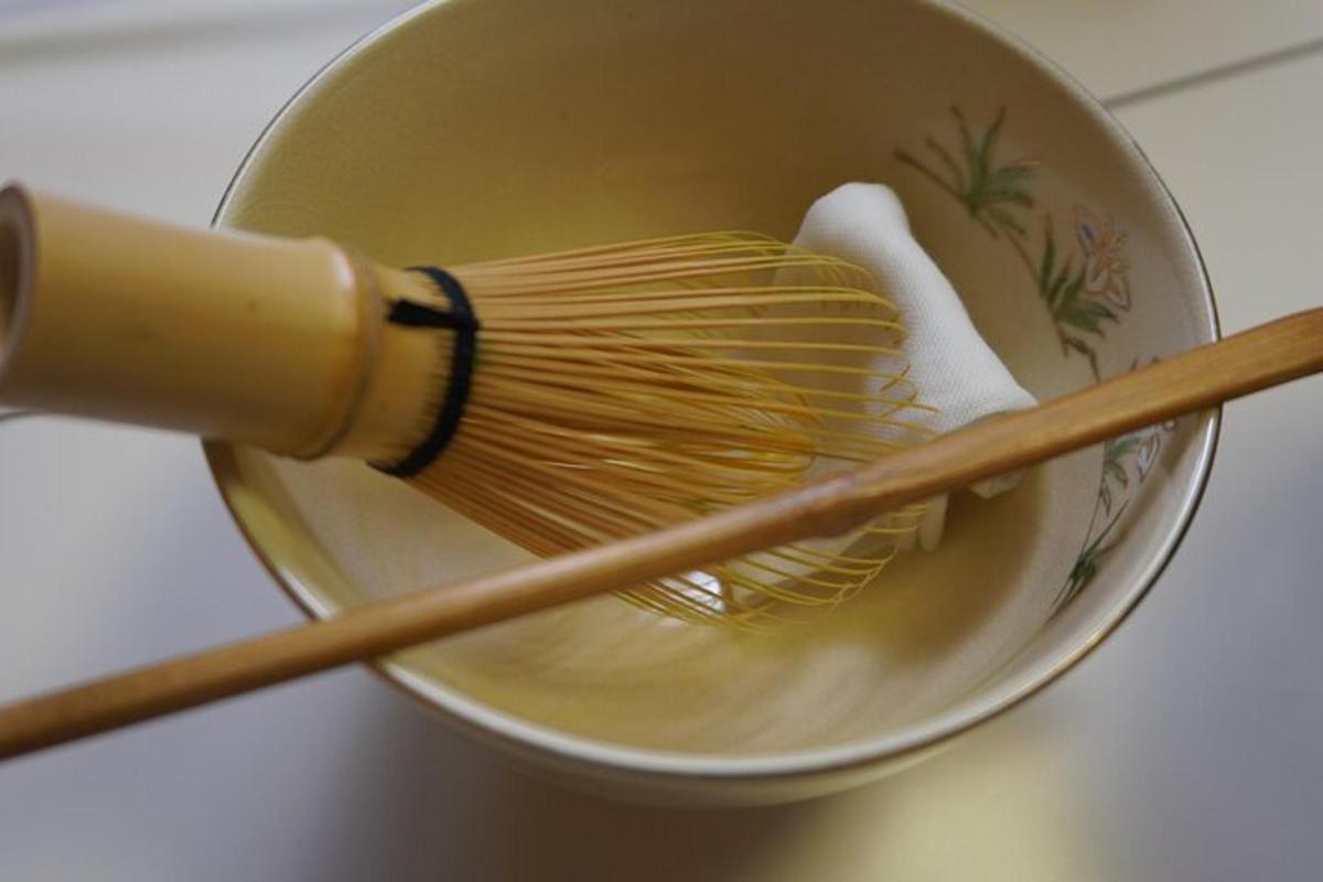 a bowl with a whisk and wooden chop sticks