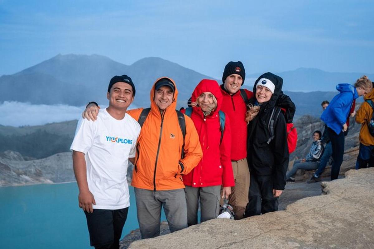 a group of people standing on top of a mountain
