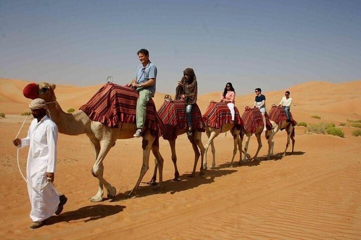 Un grupo de personas montando camellos en el desierto.