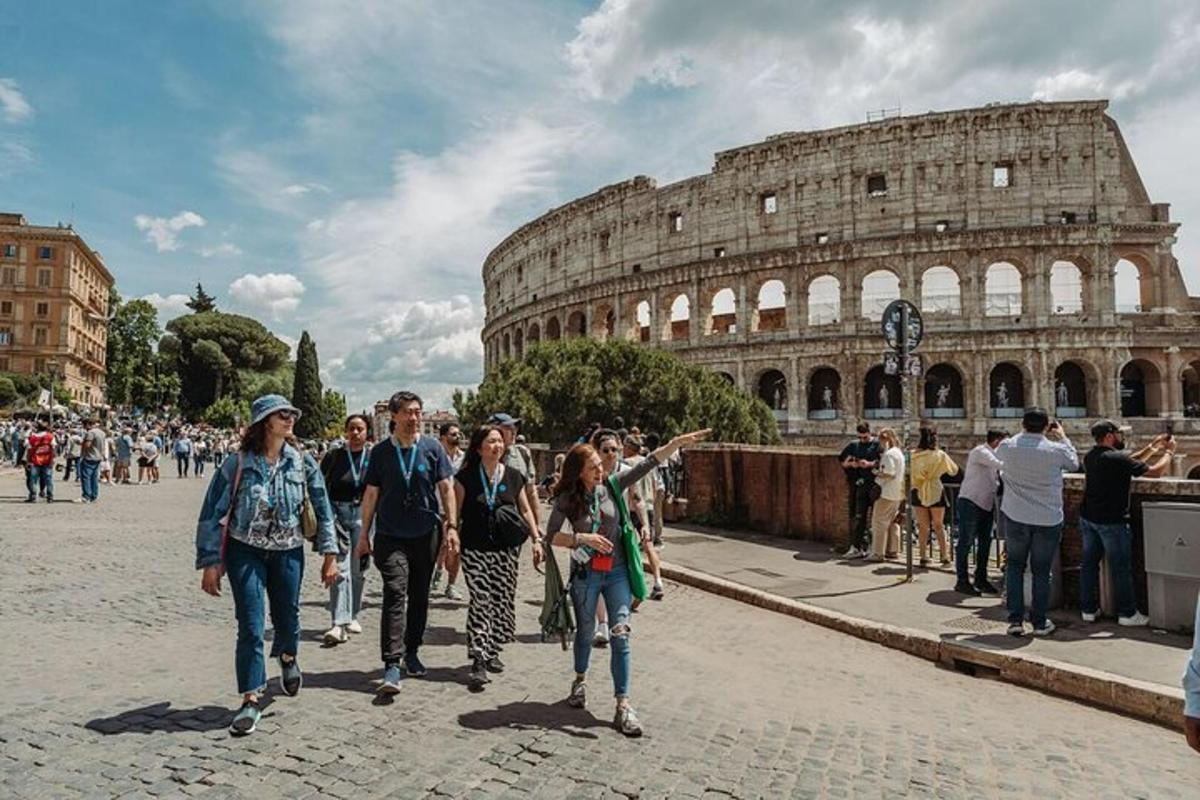 a group of people walking in front of the coliseum