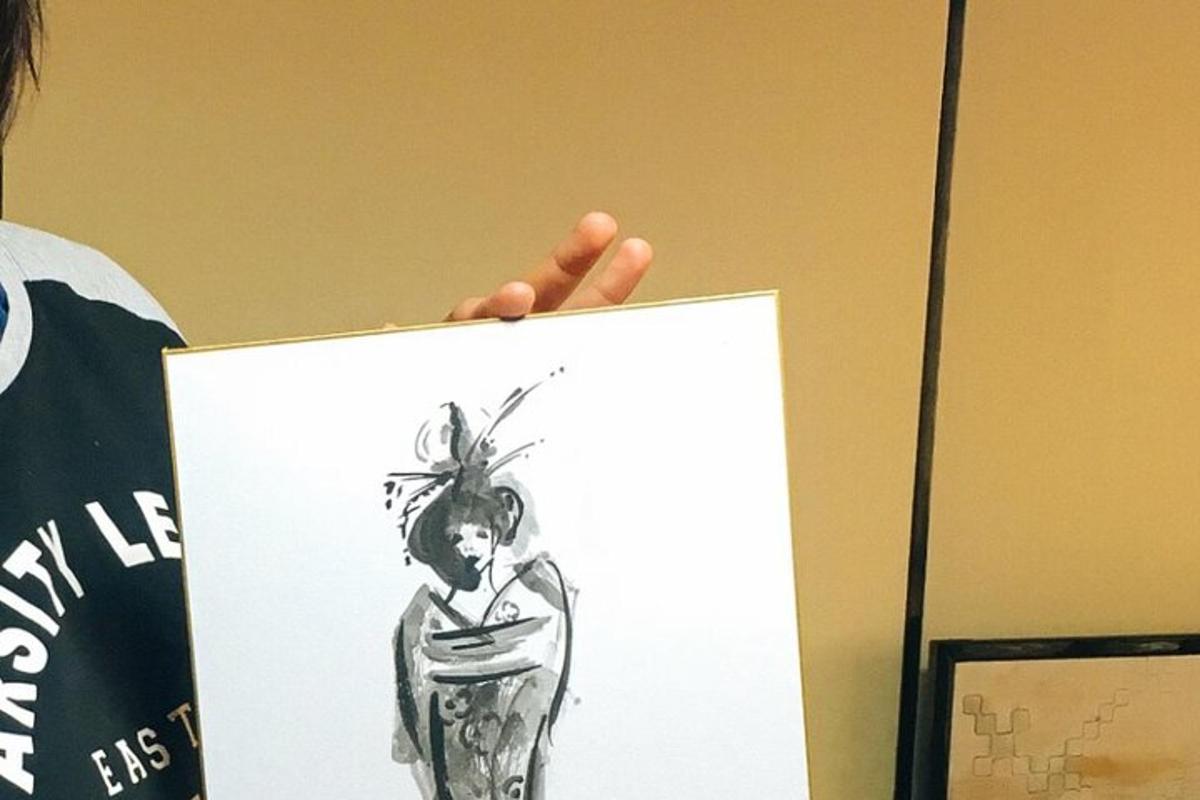 una persona che tiene in mano un disegno di una donna