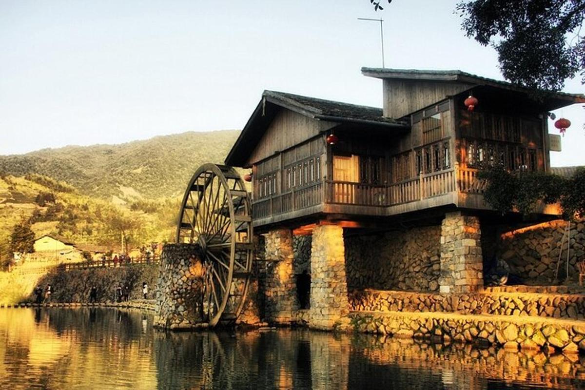 a building with a large wheel in the water
