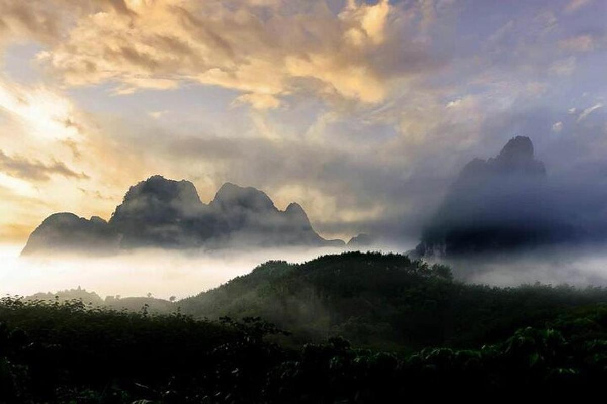 một thung lũng sương mù với những ngọn núi và những đám mây trên bầu trời