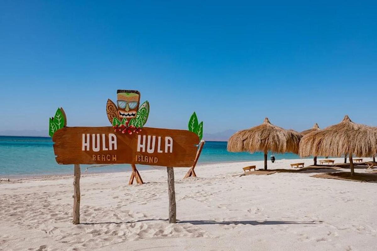 a sign for a hotel on a beach