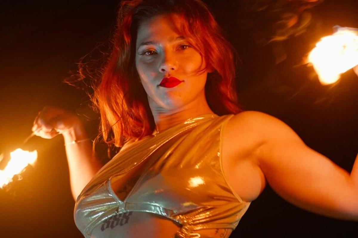 a woman with red hair and makeup on her face