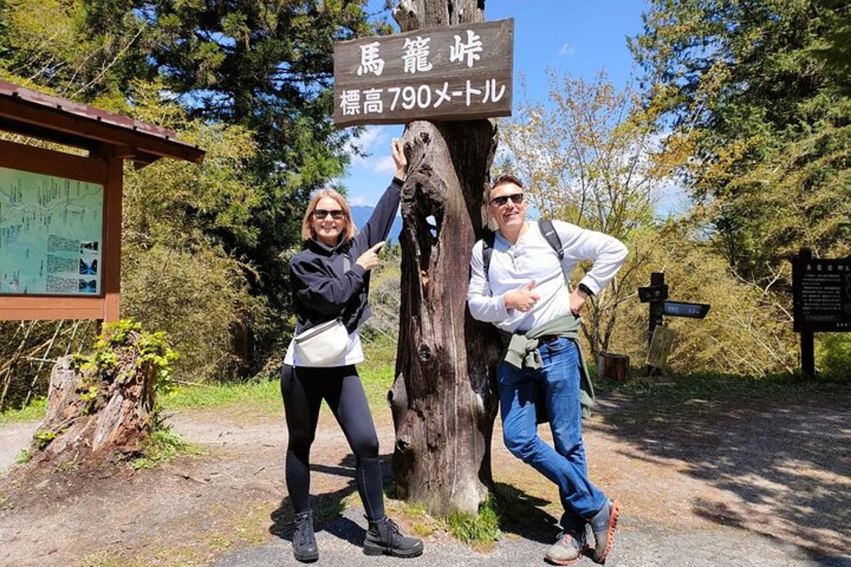 two people standing in front of a sign