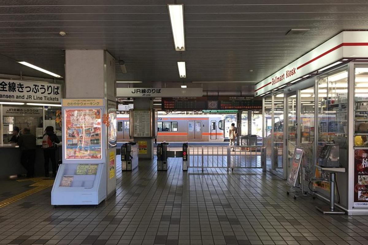 a subway station with a train in the background
