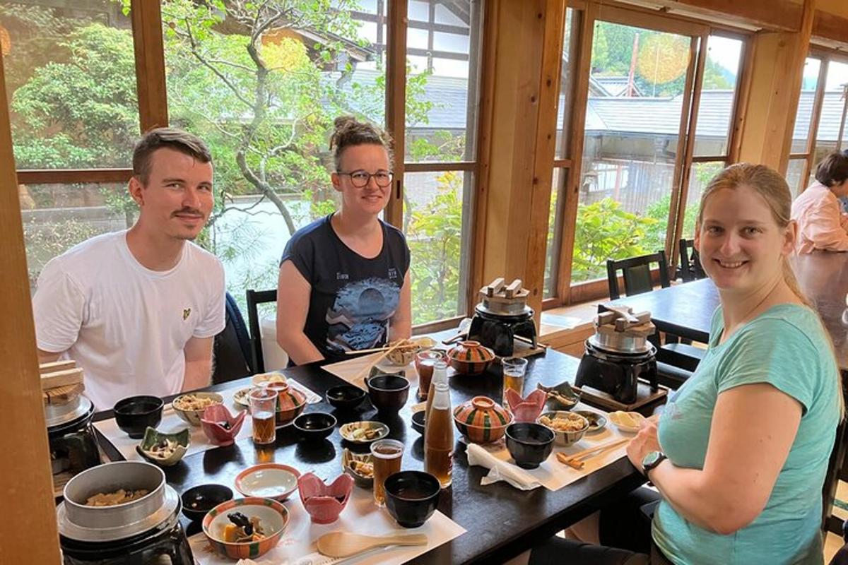 a group of people sitting at a table with food