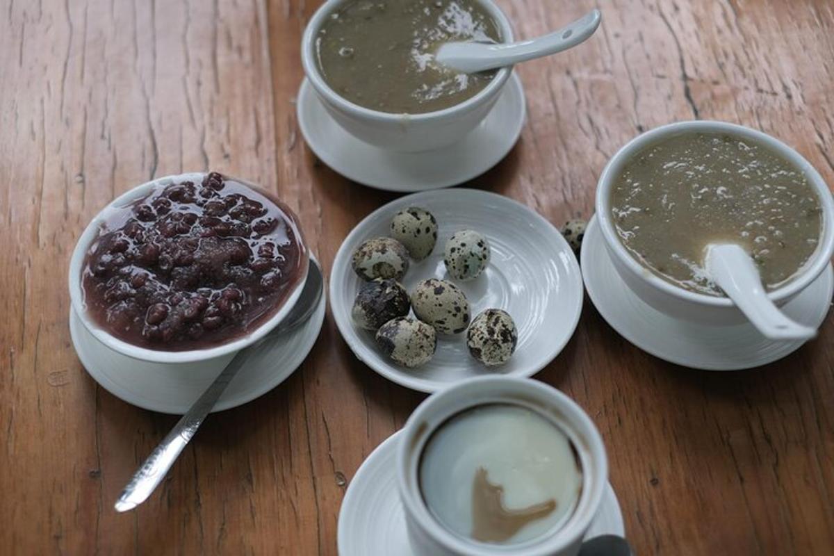 a table with four cups of coffee and bowls of food