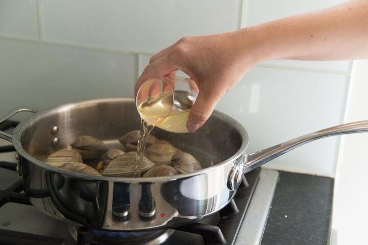 a person is cooking food in a pot on a stove