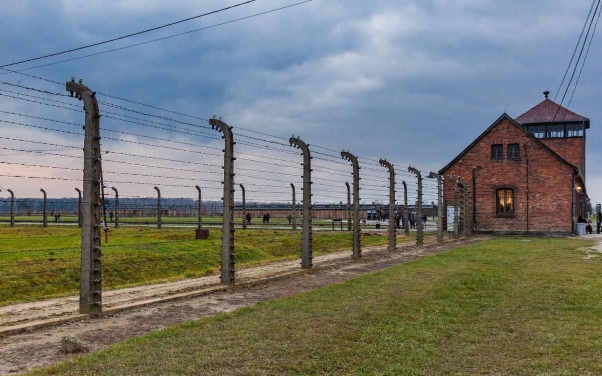 an old fence next to a brick building