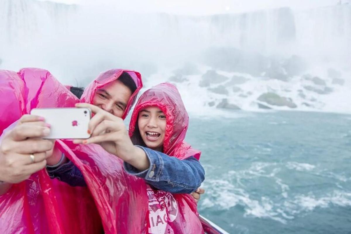 a man and a woman taking a picture of a waterfall