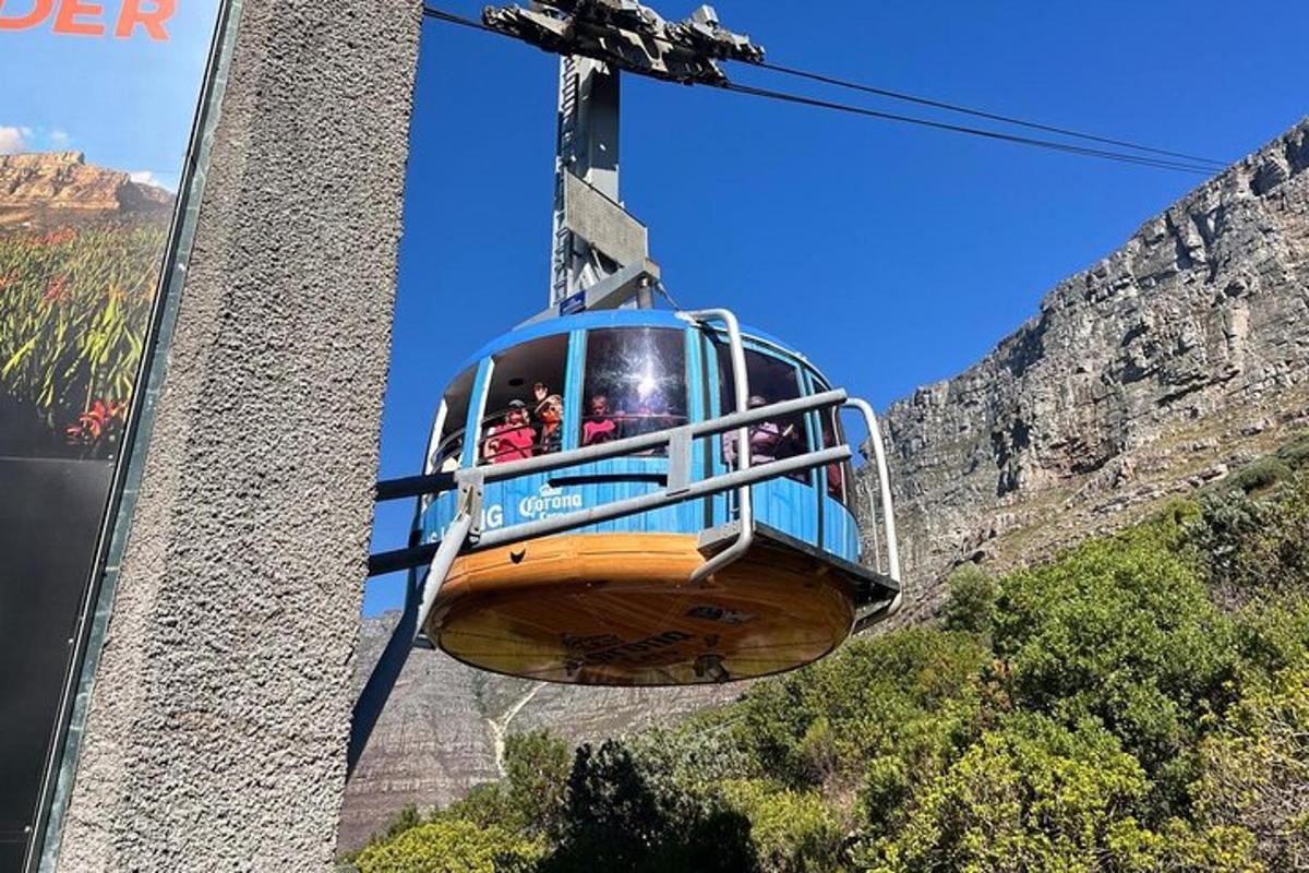 a group of people riding a gondola over a mountain