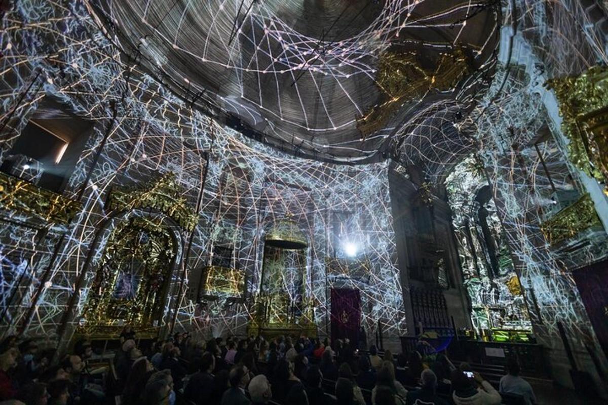 a crowd of people standing in a room with lights