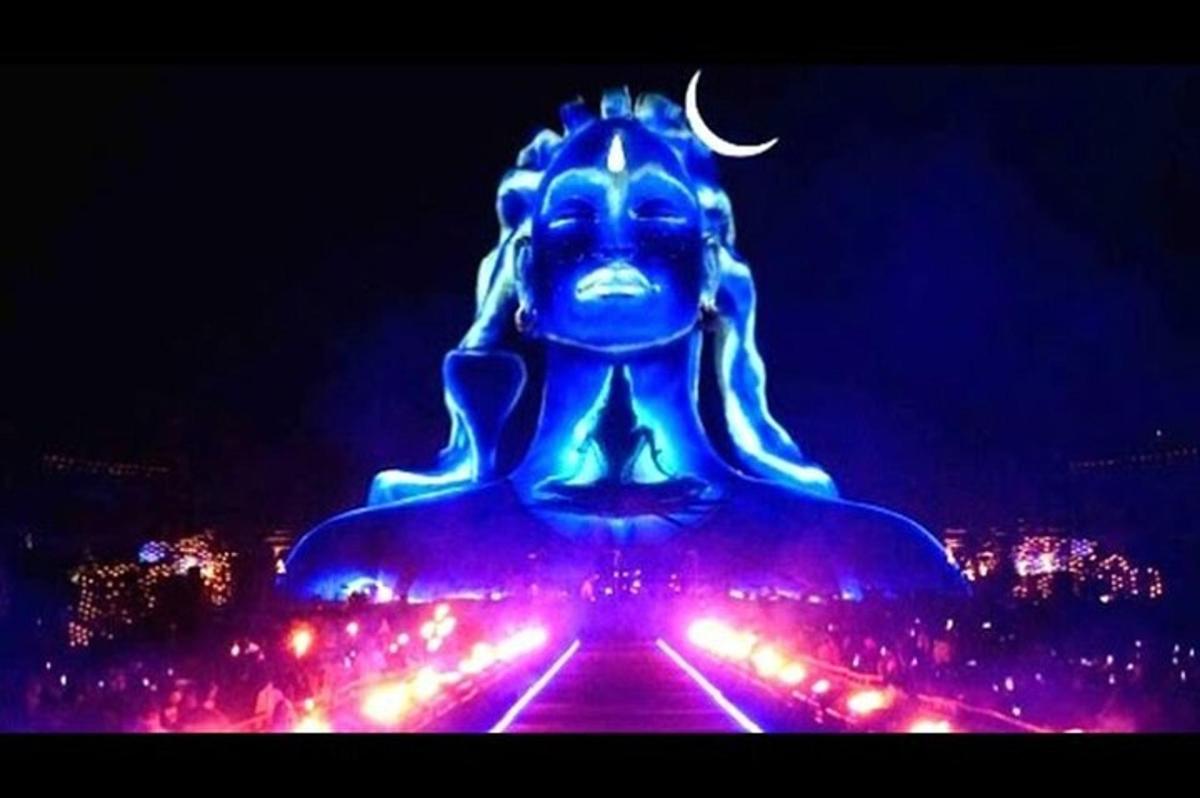 a large blue statue with lights in a city