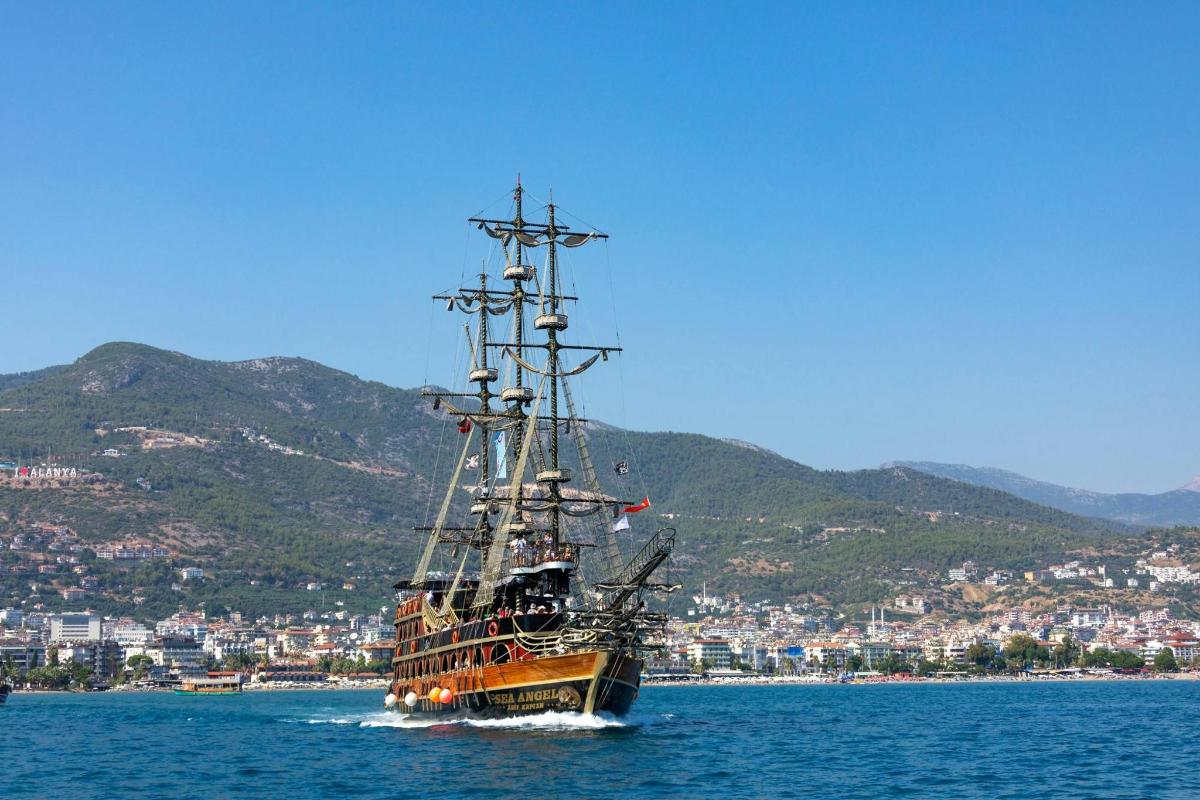 a large boat in the water near a city