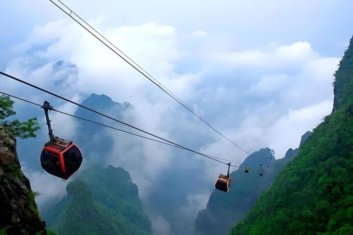 two gondolas on a cable car above the mountains