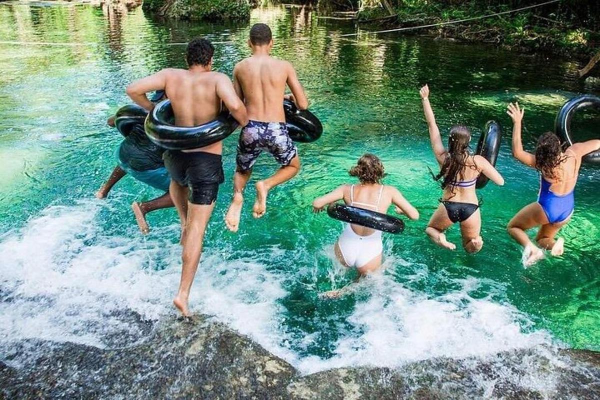 a group of people jumping into a body of water