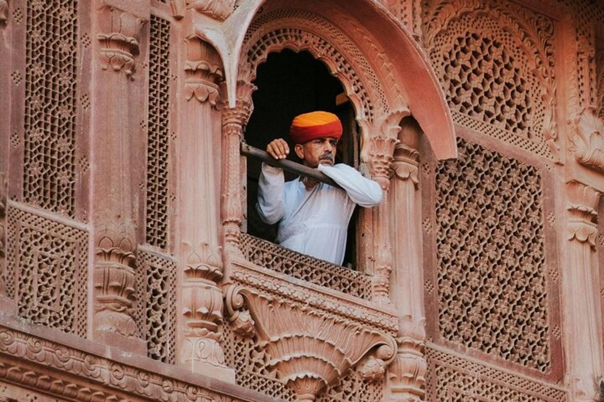 a man looking out of a window in a building