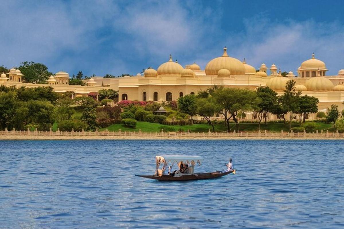 a boat in the water in front of a large building