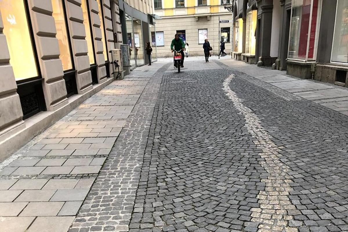 henkilö ajaa pyörällä mukulakivikadulla