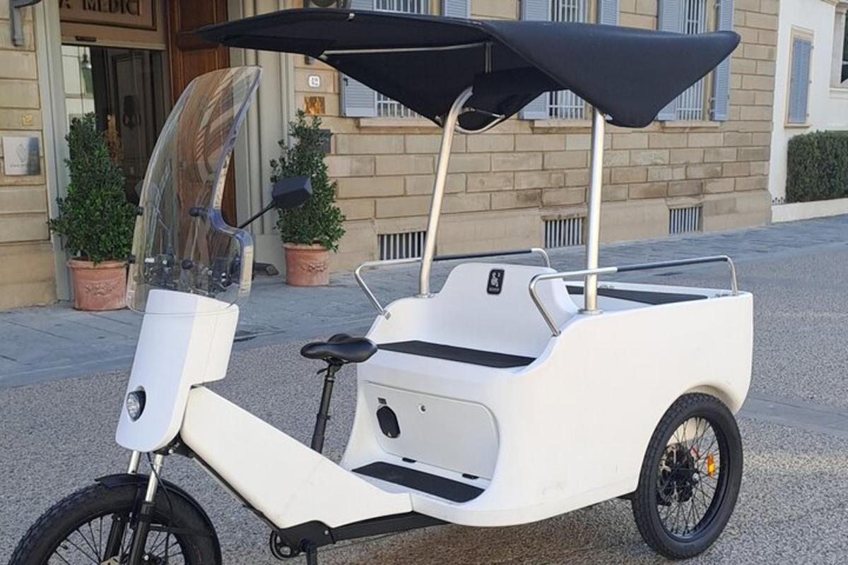a white scooter with an umbrella on a street