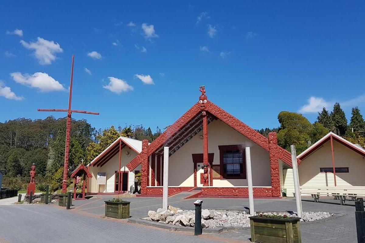 a church with a cross on the side of a street
