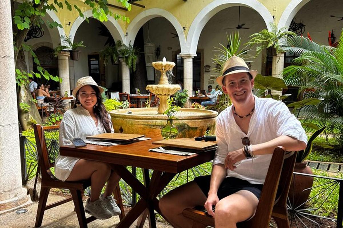 un home i una dona asseguts a una taula en un pati