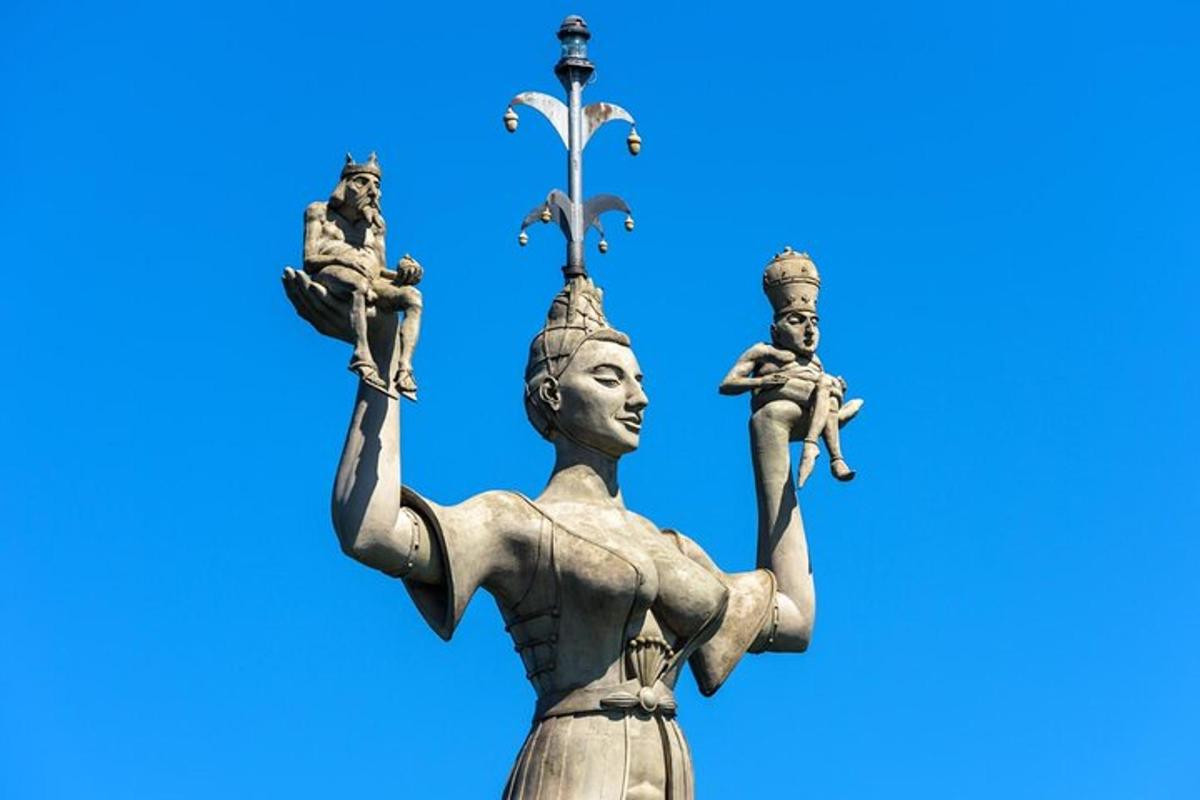 a statue of a woman with a cross on her head