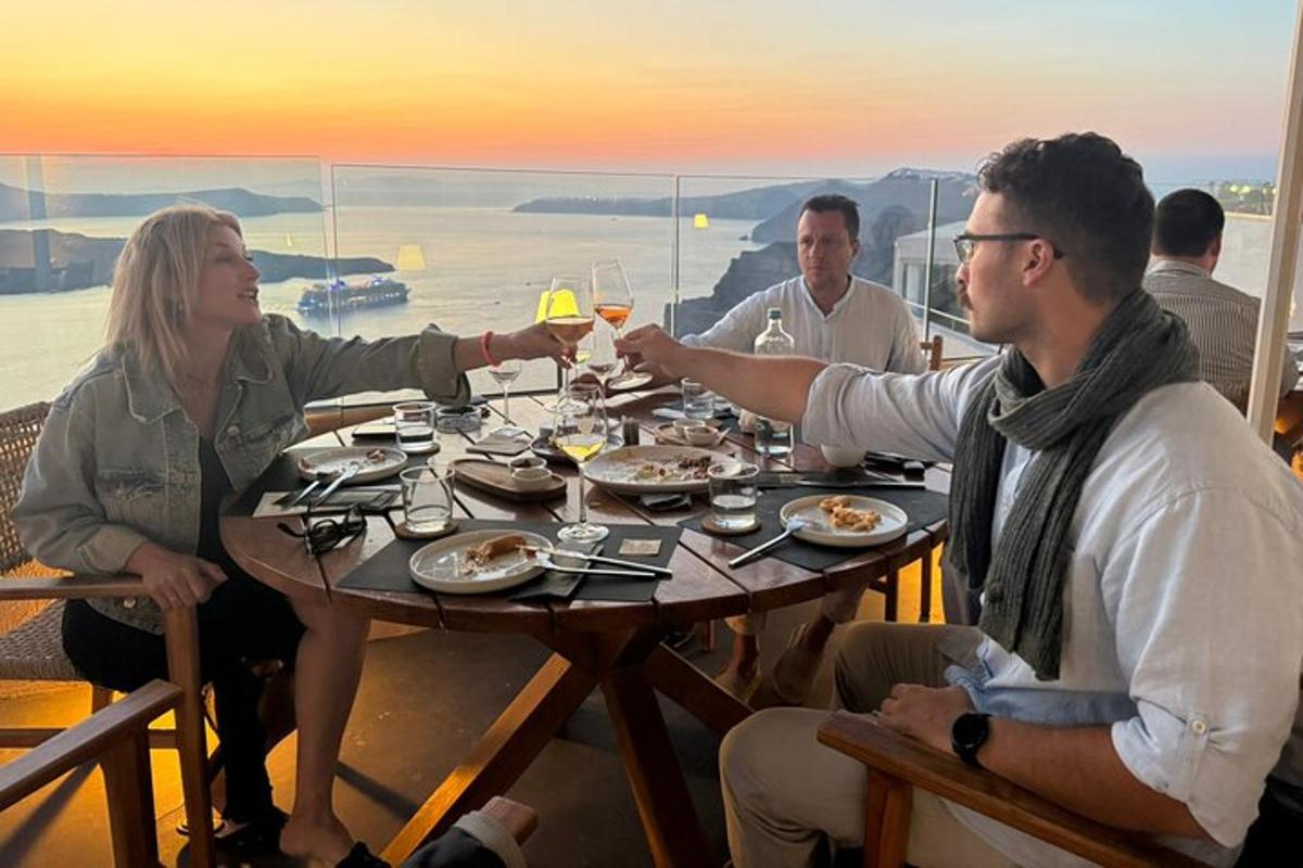 a group of people sitting at a table with wine glasses