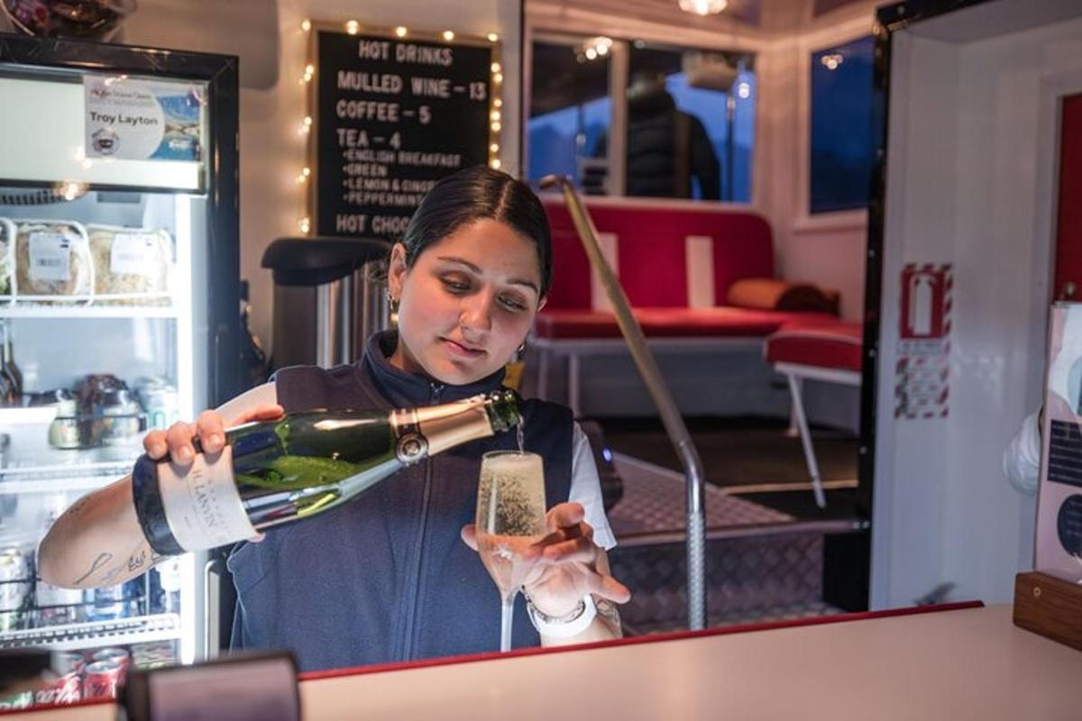 a woman pouring a bottle of wine in a store