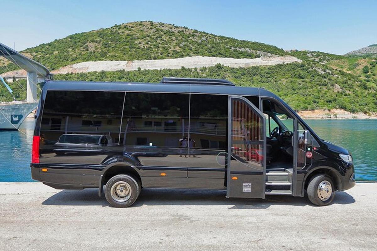 a black van parked next to a body of water