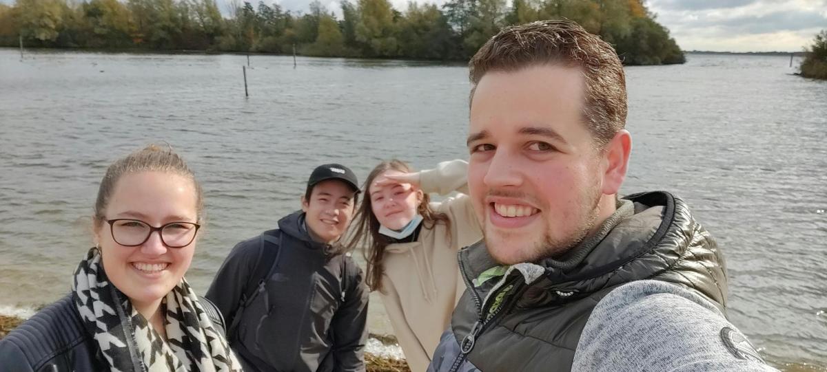 skupina lidí stojících u vodní plochy