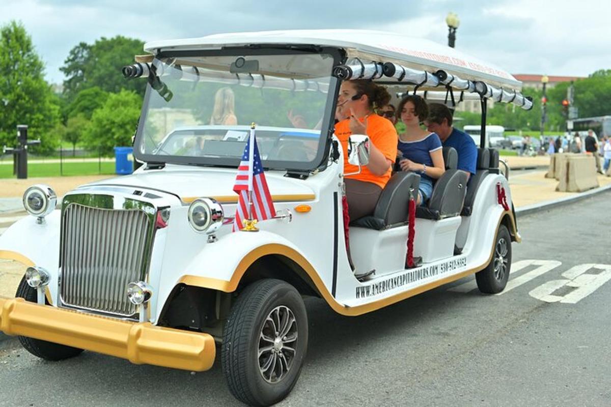 a group of people riding in a golf cart