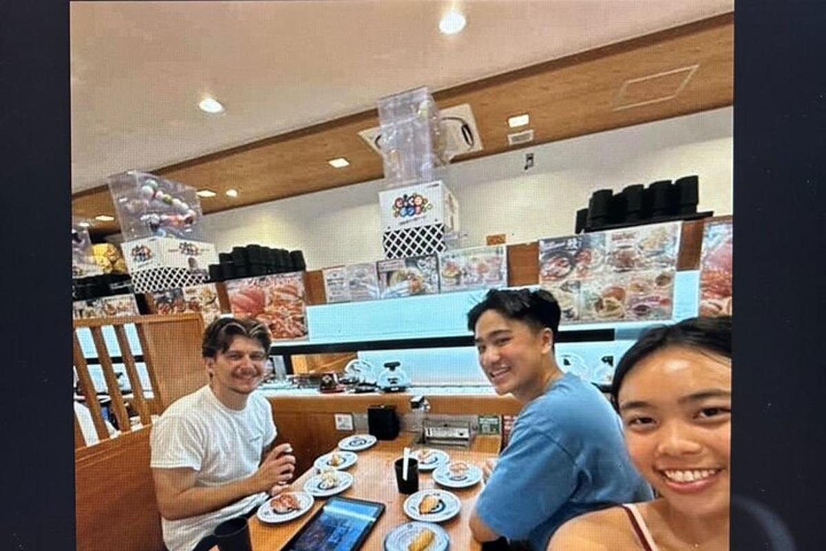 一群人坐在餐厅的一张桌子旁
