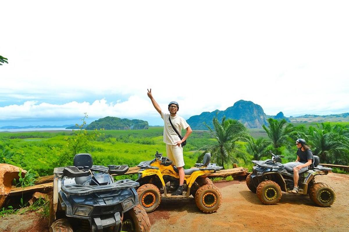 a man standing on a four wheeler with his arms in the air