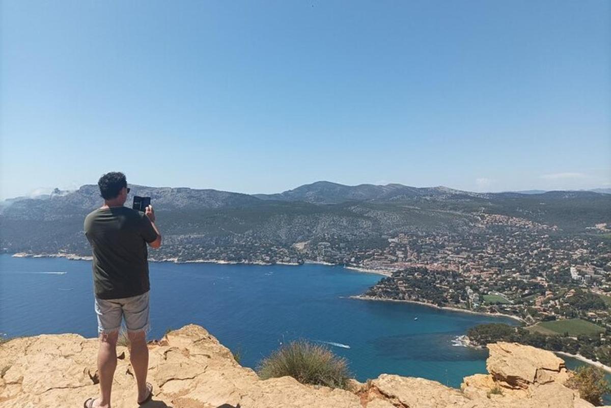 a man standing on top of a mountain taking a picture
